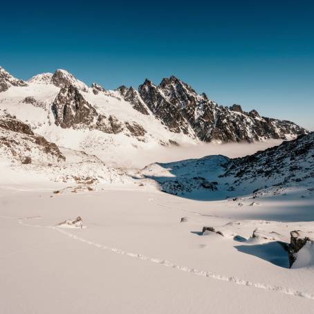 Alpine Peaks in Winter Sunset Over Snowy Landscape