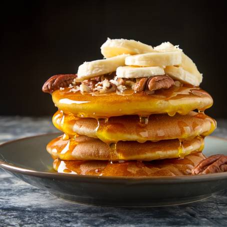 American Pancakes with Maple Syrup and Butter on White Plate