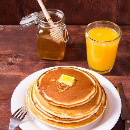 American Pancakes with Syrup and Butter Isolated on White