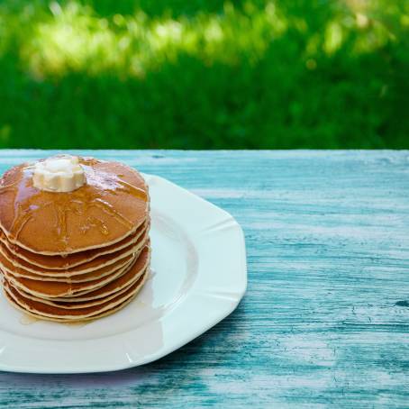 American Pancakes with Syrup and Butter on White Isolated Plate