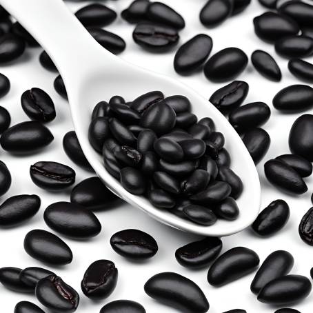 Black Beans in White Ceramic Spoon Isolated on Dark Background Close Up Food Image