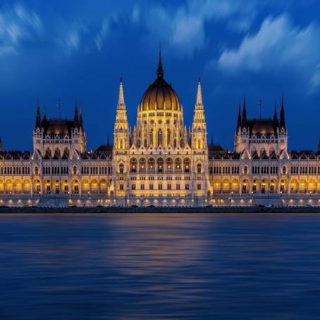 Budapest Illuminated Parliament Building Reflected in Serene Danube River at Night