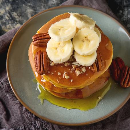 Butter and Syrup Topped Pancakes on White Background