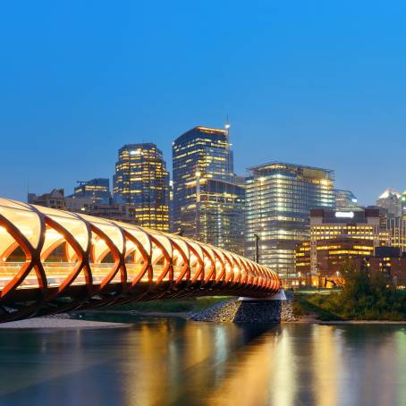 Calgarys Peace Bridge and Downtown Reflected in Bow River at Night