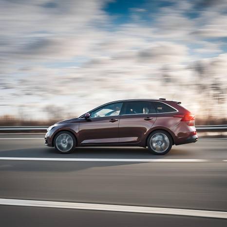 Car Racing on Riga Highway Side View with Focused Motion Effect