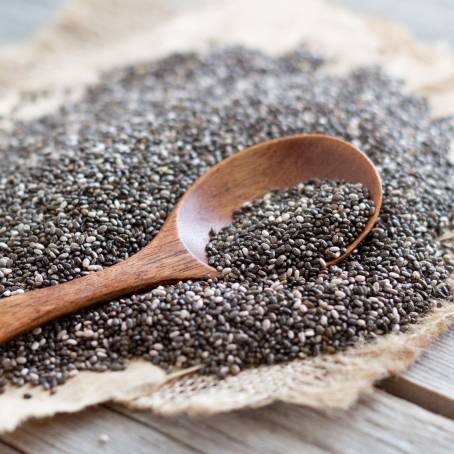 Chia Seeds in a Wooden Spoon on a Rustic Table with Natural Light