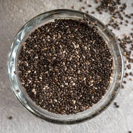 Chia Seeds in a Wooden Spoon with Health Benefits Displayed on a Modern Counter