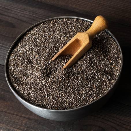 Chia Seeds in a Wooden Spoon with Nutrients Highlighted on a Clean Surface