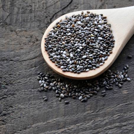 Chia Seeds in a Wooden Spoon with Omega3 and Protein on a Clean Surface