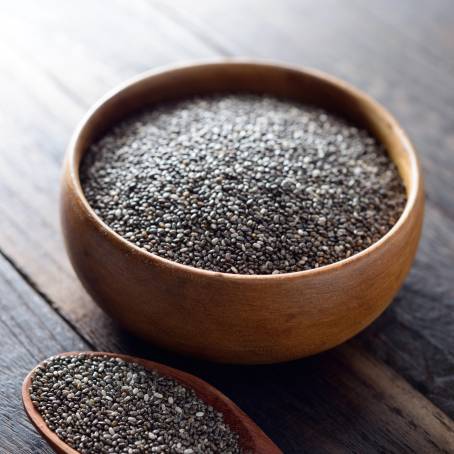 Chia Seeds on a Wooden Spoon with Antioxidants and Omega3 on a Clean Table