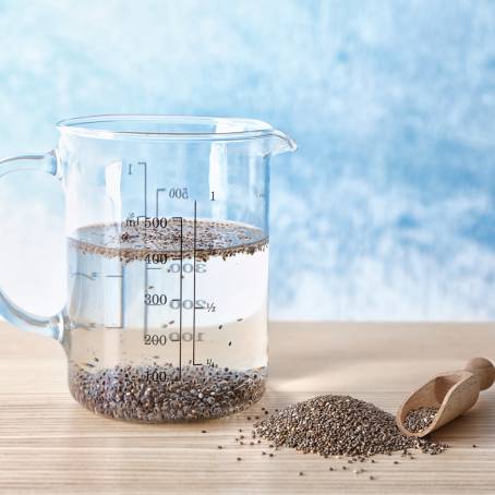 Chia Seeds with Fiber and Omega3 in a Wooden Spoon on a White Surface