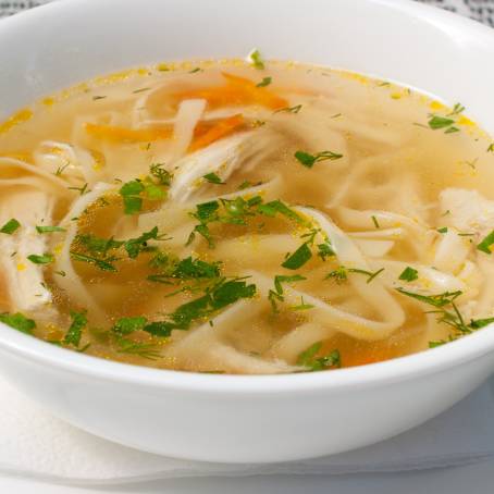 Chicken Noodle Soup Broth Isolated on White, Savory Comfort Food, Warm and Homemade Delight