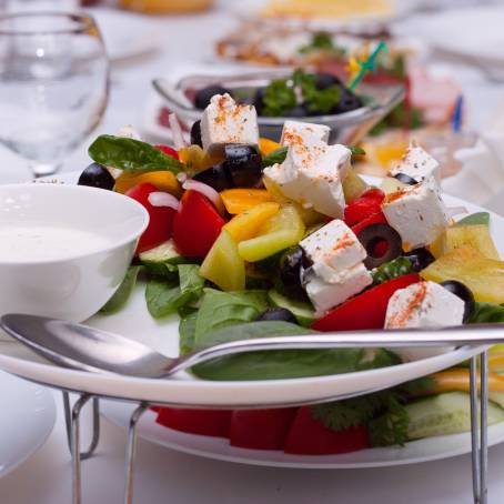 Classic Greek Salad with Cheese and Fresh Vegetables on White Background