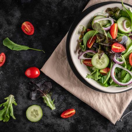 Close Up Salad Bowl with Spinach, Cherry Tomatoes, Lettuce, Cucumber and More Isolated