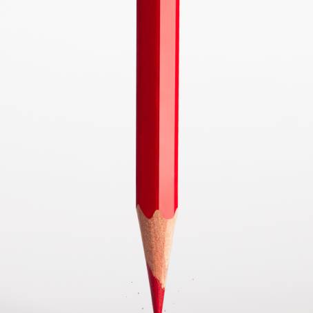 CloseUp of Broken Pencil Tip with Graphite and Red Background