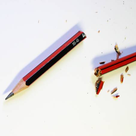 CloseUp of Broken Wooden Pencil Tip on Red Background