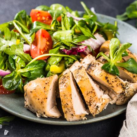 Closeup of Chicken Salad with Ripe Tomatoes and Crisp Lettuce