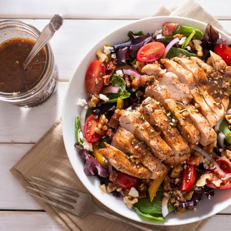 Closeup of Chicken Salad with Sweet Tomatoes and Leafy Greens