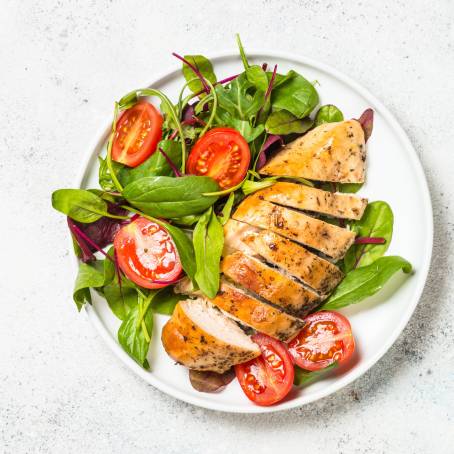 Closeup of Delicious Chicken Salad with Tomato and Crunchy Lettuce