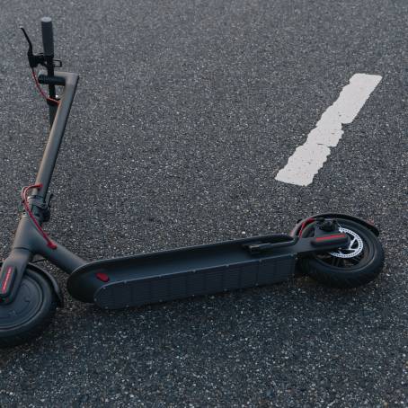 CloseUp of Electric Scooter on Road Green Urban Mobility