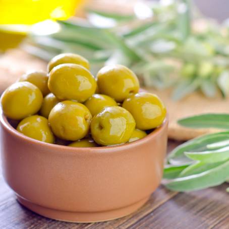 CloseUp of Green Olives and Slices in Air