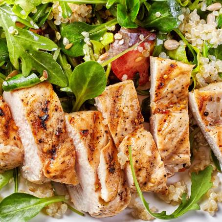 Closeup of Nutritious Chicken Salad with Tomato and Mixed Greens