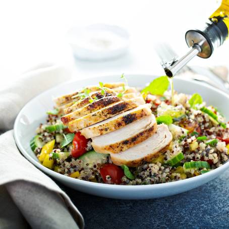 Closeup of Tender Chicken Salad with Cherry Tomatoes and Greens