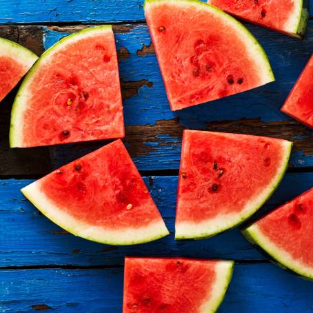 CloseUp of Watermelon Slice on Blue Background, Fresh and Juicy Fruit, Summer Treat, Vibrant Color