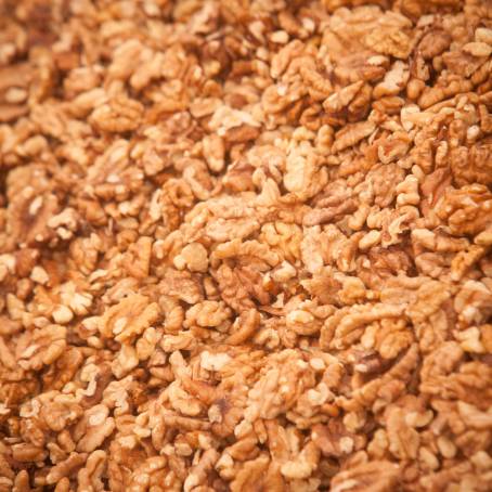 CloseUp Pile of Peeled Walnuts on White Background