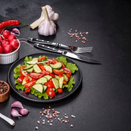 Colorful Salad Bowl with Spinach, Cherry Tomatoes, Lettuce, and Cucumber on White Background