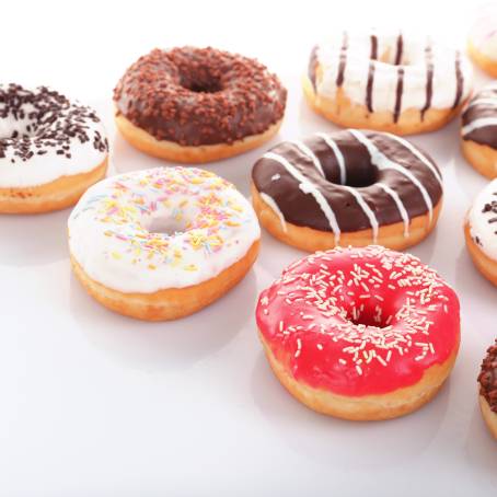 Colorful Strawberry Donuts with Glaze and Sprinkles on White Background