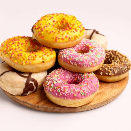 Colorful Strawberry Glazed Donuts with Fun Sprinkles on White Background