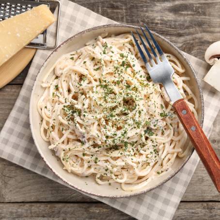 Creamy Mushroom Pappardelle Overhead View with Parsley and Stone Background