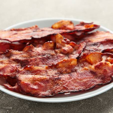 Crispy Bacon Slice Isolated on White with Golden Touch