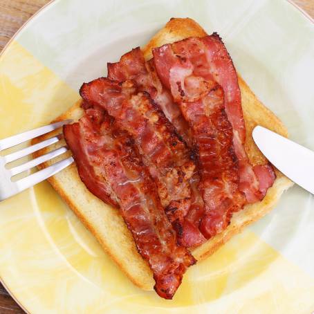 Crispy Fried Bacon Slice on Clean White Background