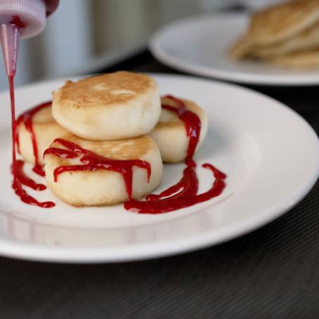 Delicious Pancakes with Syrup and Butter on White Background