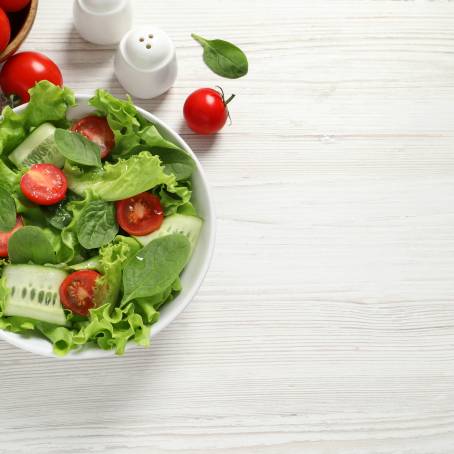 Delicious Salad with Spinach, Cherry Tomatoes, Lettuce, Cucumber and More in Bowl, Isolated