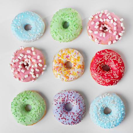 Delicious Strawberry Donuts with Sprinkles on a Bright White Background