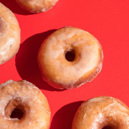 Delicious Strawberry Donuts with Sprinkles on a Pure White Background