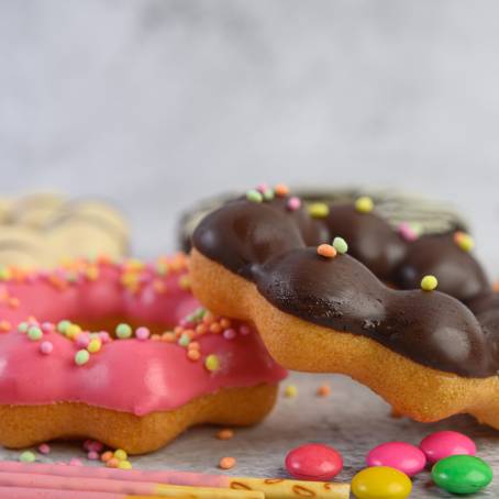 Delicious Strawberry Glazed Donuts with Bright Sprinkles on White Background