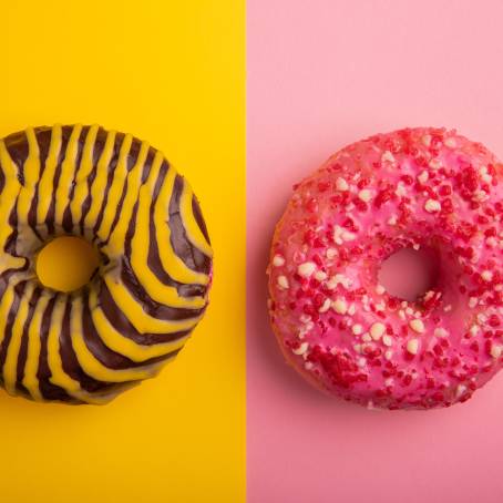 Delicious Strawberry Glazed Donuts with Colorful Sprinkles on a White Surface