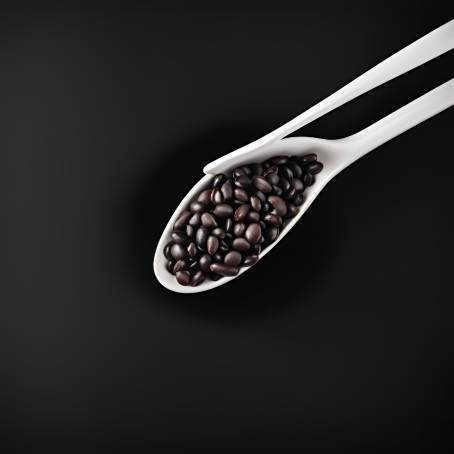 Detailed CloseUp of Black Beans in White Ceramic Spoon on Black Background Isolated Food Photography