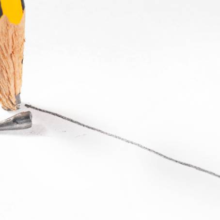 Detailed CloseUp of Broken Pencil Tip with Graphite on Red Background