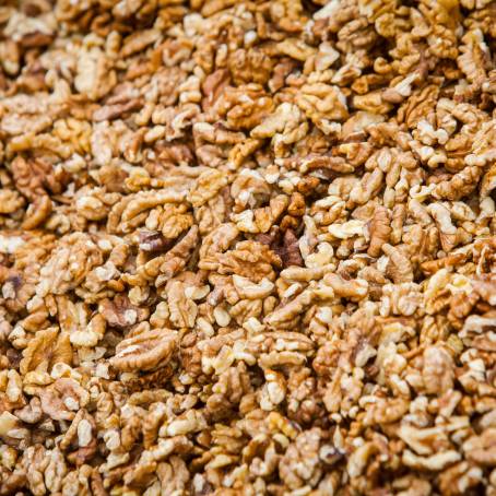 Detailed Peeled Walnuts Pile on White Surface