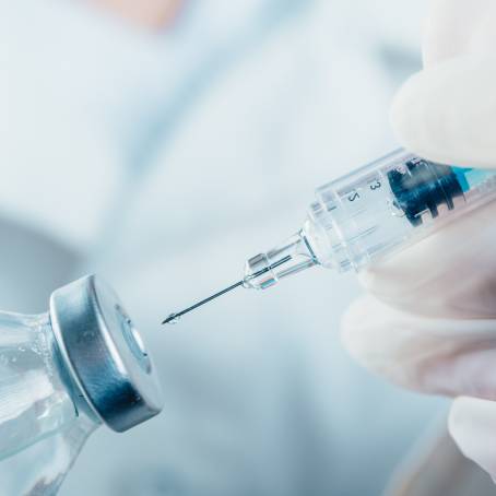 Doctor Holds COVID19 Vaccine Syringe Ready for Immunization