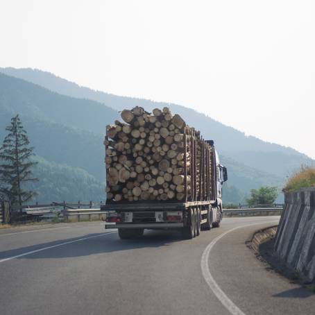 Driving Loaded Farm Truck Through Green Hills