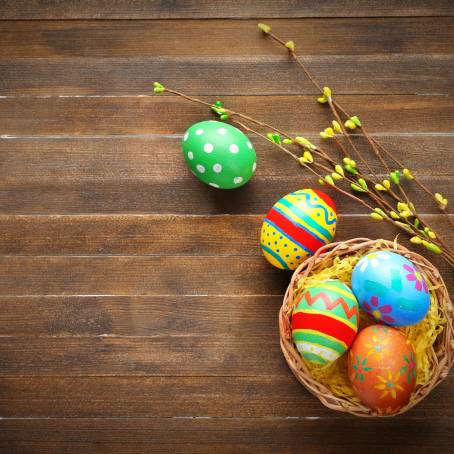 Easter Eggs and Basket on Wooden Surface