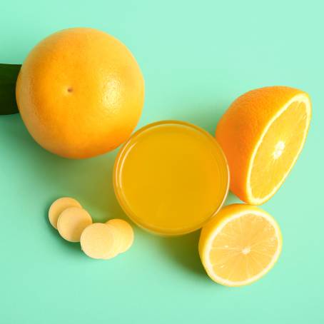 Effervescent Orange Vitamin C Dissolving in Water Close Up View