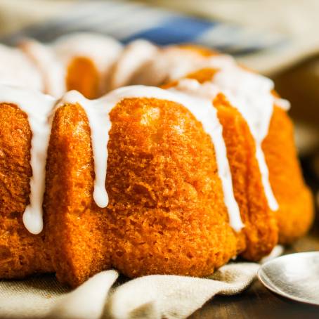 Elegant Lemon Bundt Cake with Powdered Sugar Glaze Displayed on a Stand