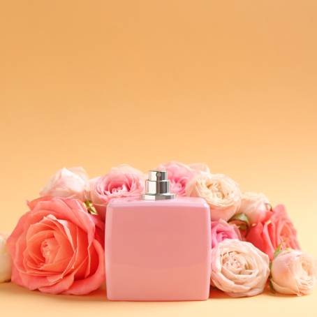 Elegant Roses and Perfume Bottles on Pink Background